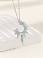 Macro shot of silver crescent pendant with turquoise beads and zircon on white stand - Silver