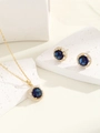 Detailed view of luxury jewelry set with blue sapphire stones and zircon halo on white stone - Gold Royal Blue