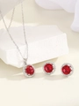 Macro shot of silver jewelry set featuring red zircon necklace and matching stud earrings - Silver Red Zirconia