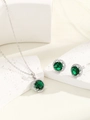 Macro shot of sparkling emerald green halo jewelry set with necklace and earrings on stone - Silver Green Zircon