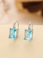Macro view of silver earrings with large rectangular blue gemstone and sparkling zirconias - Square (TE-09702-06)