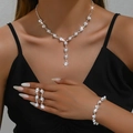Elegant silver jewelry set with white pearls and rhinestones on a female model - 858747 Silver Necklace Earrings Bracelet Pearl Set