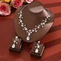 Macro shot of silver flower necklace and pear-cut zircon earrings with leaf shadows - Vine Flower Style (1729) / Silver