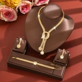 Exquisite bridal jewelry set macro view with sparkling crystals on elegant brown leather stand - Gold