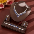 Elegant bridal jewelry set with blue teardrop pendants and white crystals on display - Three-Piece Set / Blue