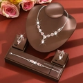 Detailed view of pink crystal flower necklace and earring set on professional jewelry stand - Three-Piece Set / Pink