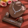 Macro detail of luxury silver jewelry set with blue gems and white crystals in a display - Three-Piece Set / Blue