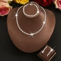 Elegant silver jewelry set with rhinestone lightning patterns on a brown display stand - HB1329785 Set / Silver
