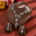 Macro detail of bridal jewelry set with sky blue floral rhinestones on a neck display - Set / Sky Blue