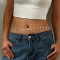 Minimalist silver star waist chain worn by model over denim jeans for a stylish look - Pentagram Style (WLBC0025)