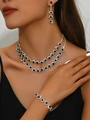 Detail of sunflower halo jewelry set with black stones and pavé diamonds on a model - Necklace Earrings Bracelet Set (484798) / Black
