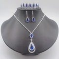 Detailed shot of bridal jewelry set with navy blue crystals and silver necklace earrings - Necklace Earrings and Tiara 3-Piece Set (670600) / Blue