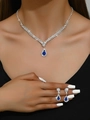 Silver jewelry set with blue teardrop stones and rhinestones worn by a model - Blue Necklace Earrings