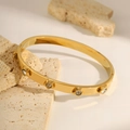 Polished gold stainless steel bangle featuring 3D star motifs with sparkling rhinestones - Gold Star Bracelet