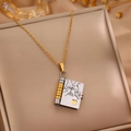 Golden and silver love letter book pendant necklace on a beige velvet jewelry gift box - Two-tone