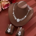 Elegant zircon jewelry set with floral necklace and earrings displayed in a luxury setting - White Necklace and Earrings