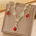 Detail view of pear-cut red zircon jewelry set with necklace and earrings in a velvet gift box - Gold Tone Red (1454 Gold Red)