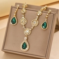 Close-up of luxury geometric necklace and earrings set with emerald green waterdrop stones - Gold Tone Emerald (1454 Gold Green)