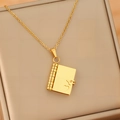 Detailed macro of a gold book-shaped envelope pendant with heart design on jewelry box - Gold