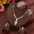 Detailed view of silver-toned rhinestone bridal jewelry set with tassel fringe on a neck bust - White