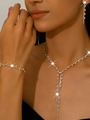 Close-up of elegant gold chain necklace with sparkling crystals on female model - Gold Necklace Earrings Bracelet