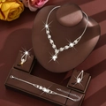 Elegant silver bridal jewelry set with sparkling rhinestones, including necklace and earrings - Necklace Earrings And Bracelet Combination / White
