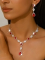 Detailed close-up of wedding jewelry set with red pear-cut crystals on a silver necklace - Necklace & Earrings Set (1662) / Red