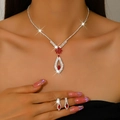 Detail of elegant teardrop necklace and earrings set with ruby red resin and crystals - 1658 Red
