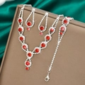 Detailed view of silver jewelry set with red rhinestones and clear zircon on silk - Necklace Earrings And Bracelet Combination / Red