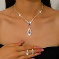 Detail of silver-tone necklace and earrings set with lavender teardrop crystals - 1658 Purple