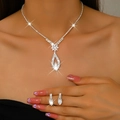 Close-up of sparkling floral rhinestone necklace and matching earrings on a model - 1658 Silver
