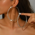 Close-up of oversized silver hoop earrings with shimmering rhinestones on a female model - Silver (Size 9)