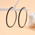 Detailed macro view of 8cm gun-black hoop earrings with pavé black rhinestones - Gunmetal Black (Size 6)