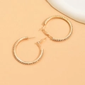 Detail view of large gold hoop earrings with sparkling crystal rhinestones and stud closure - Gold (No. 4)