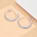 Detailed macro view of silver hoop earrings with multiple rows of sparkling rhinestones - S Size (4cm) / Silver