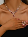 Close-up of bridal jewelry set with red gemstones and silver plating on model - Red Necklace and Earrings