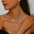 Detail of bridal jewelry set featuring red rhinestones on silver necklace and earrings - Red Necklace Earrings And Bracelet