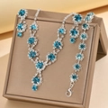 Detail of silver bridal jewelry set with sapphire blue rhinestones and snowflake design - Necklace Earrings And Bracelet Combination / Aqua