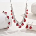 Close-up of elegant silver necklace and earring set with pear-cut red zircon stones - Red (3-Piece Set) / Red
