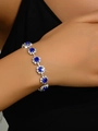 Elegant floral silver bracelet featuring round blue sapphire clusters with sparkling stars - Royal Blue Bracelet
