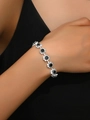 Silver flower link bracelet with black gemstones and white crystals on female wrist - Black Bracelet