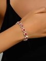 Elegant silver bracelet featuring floral links with large red crystals and small diamonds - Red Bracelet