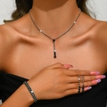 Detail of silver jewelry set with black round stones on model for formal events - Black Style (446+428-2) / Necklace Earrings Elastic Bracelet