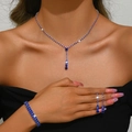 Detail of silver-tone jewelry set with deep blue crystals on a female model - Blue Style (446+428-2) / Necklace Earrings Elastic Bracelet