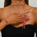 Detail view of sparkly red rhinestone jewelry set including choker, bracelet, and earrings - Red