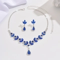 Macro detail of silver necklace and earrings set with deep blue pear-cut crystals - Necklace and Earring Set / Sapphire Blue