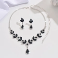 Detailed view of silver necklace and earrings set with black teardrop crystal stones - Necklace and Earring Set / Black