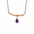 Detail of gold branch bar necklace with a purple teardrop-shaped zircon pendant - February-Purple
