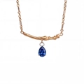 Detail of gold branch pendant with pear-cut blue zircon on a fine link chain - September-Blue