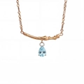 Detailed view of the gold-plated branch pendant featuring a pear-cut blue zircon stone - March-Light Blue